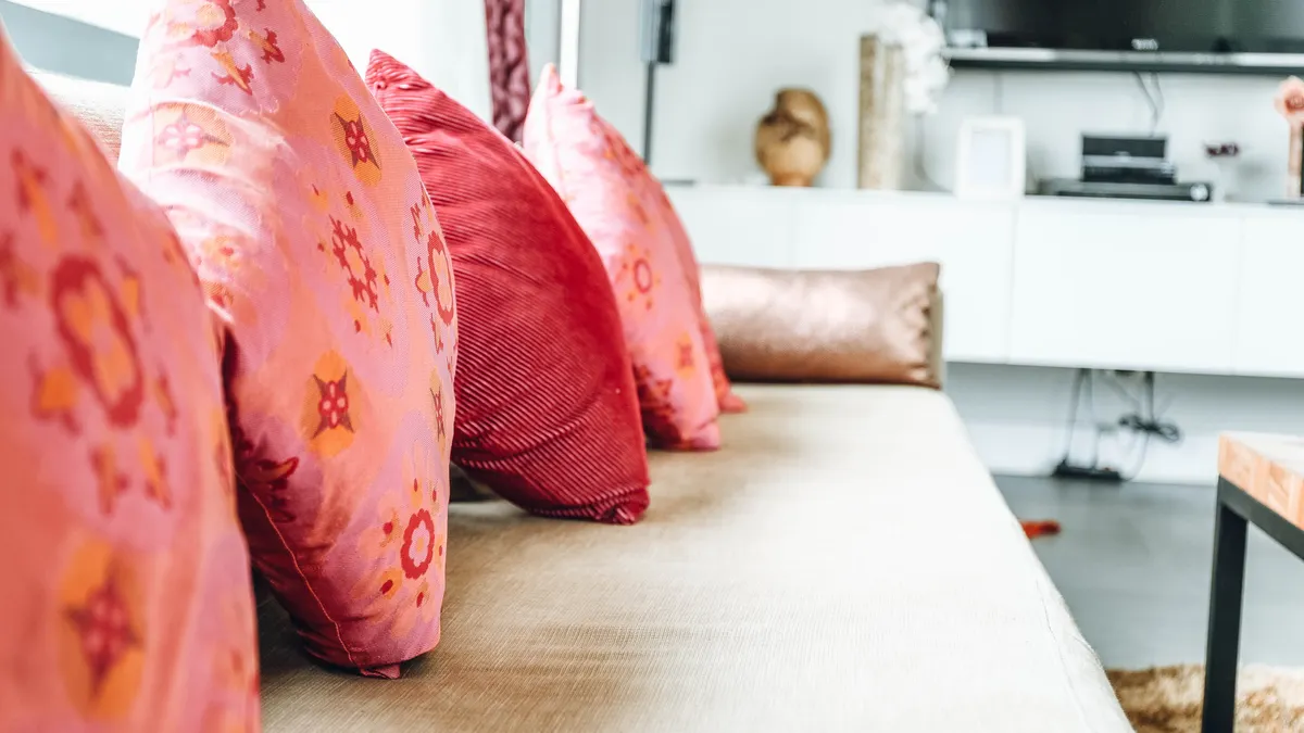 Sofa with pink patterned pillows